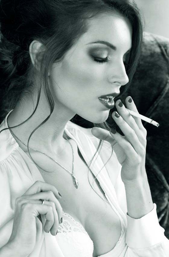 Naked brunette smoking cigar